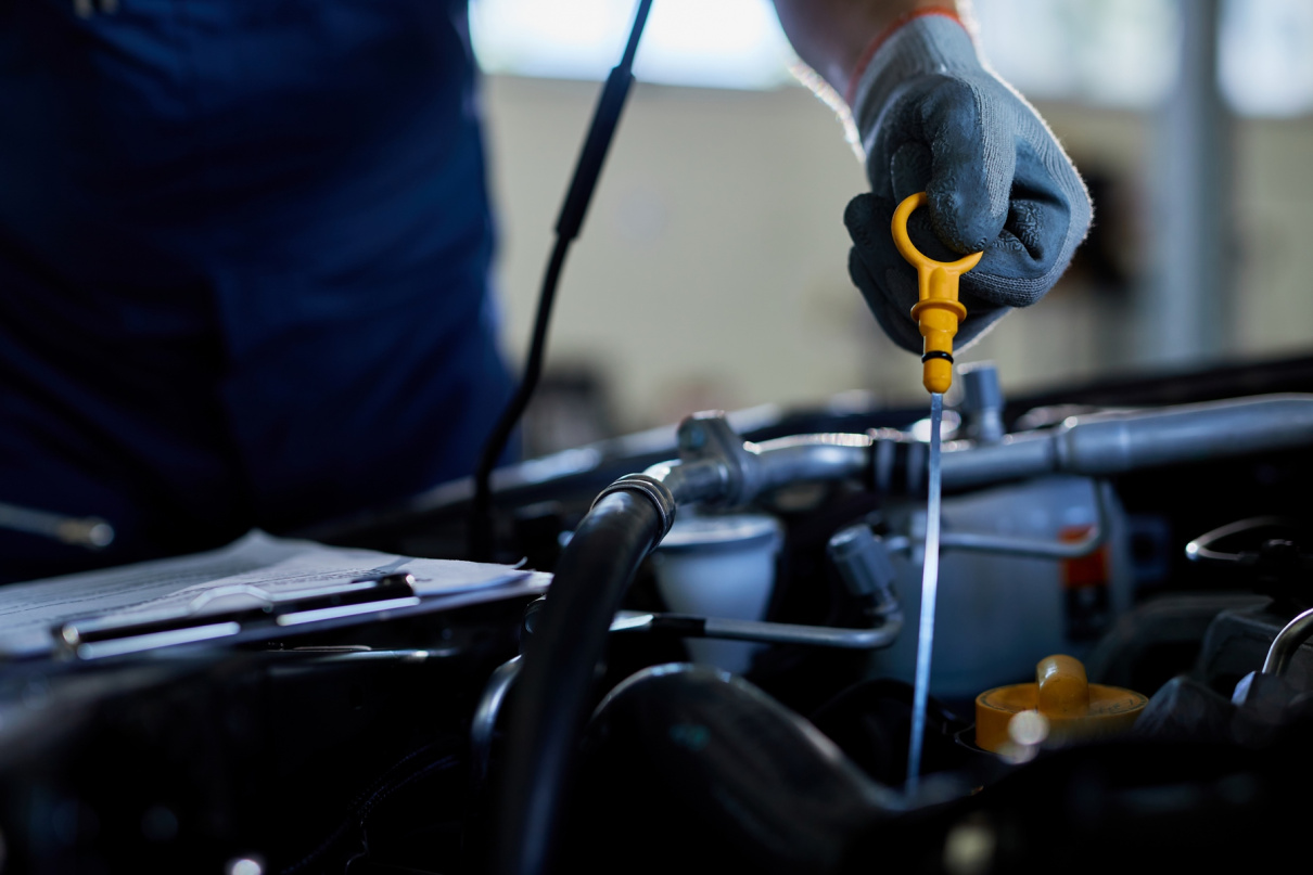 closeup-of-a-auto-repairman-checking-car-oil-in-a-workshop.jpg